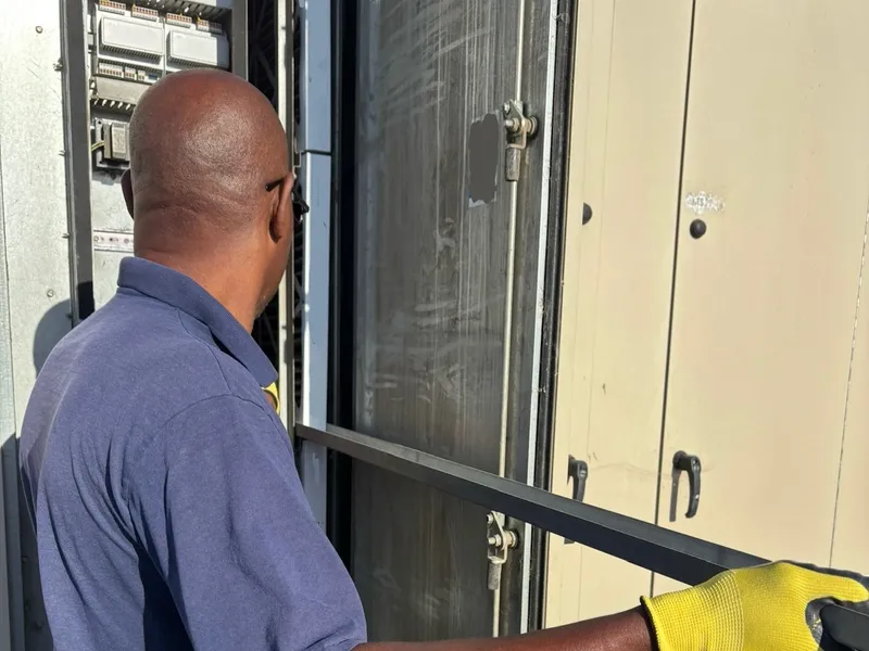 Technician servicing a packaged rooftop HVAC unit