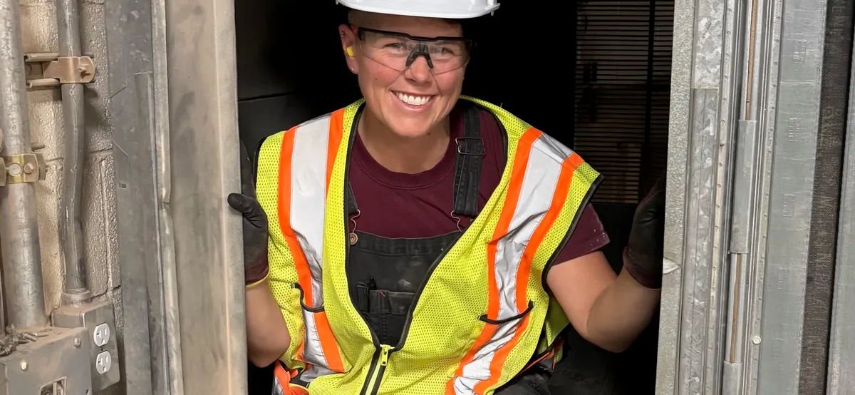 Pleasant Air technician inside an air handler access door, sizing up the filter bank