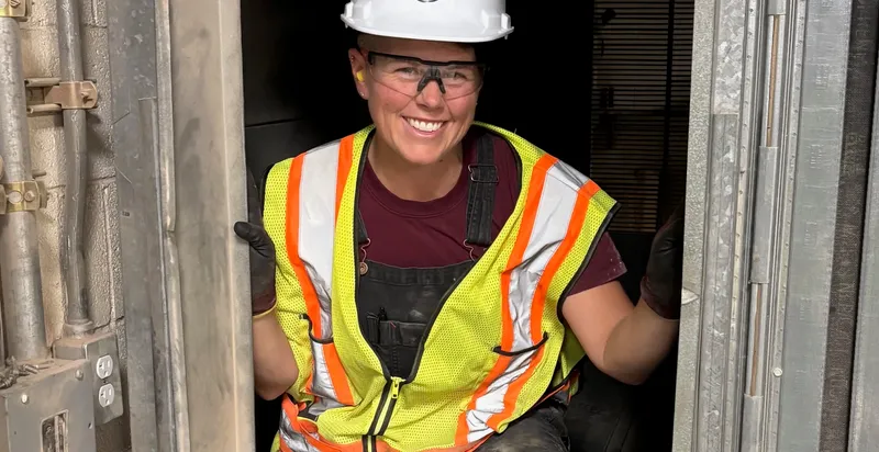 Pleasant Air technician inside an air handler access door, sizing up the filter bank